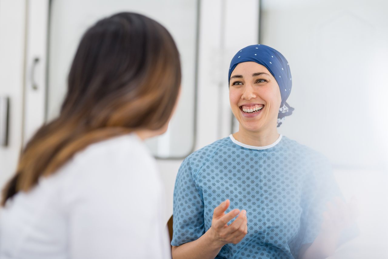 Cancer patient laughing with doctor