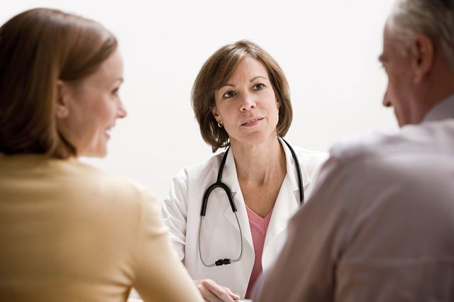 Doctor talking to couple