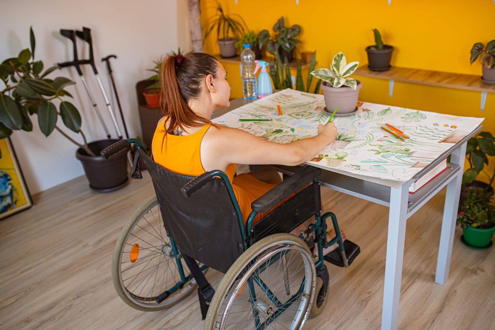 A woman in a wheelchair is coloring