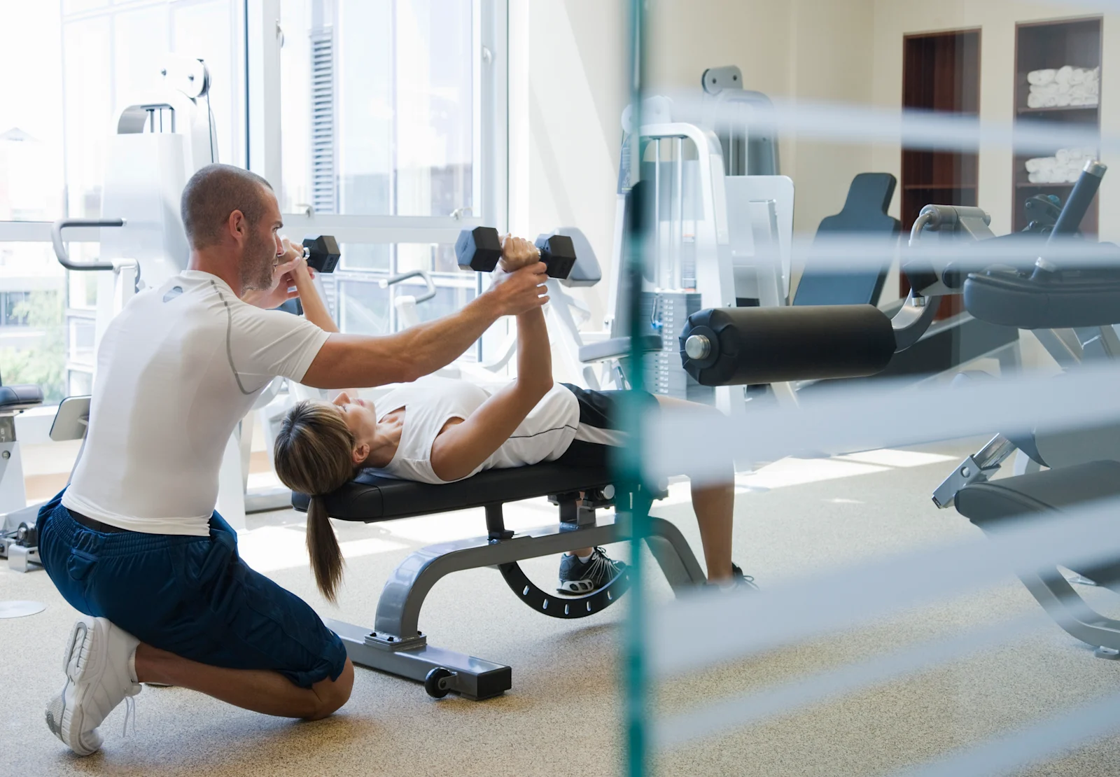 Lifting dumbells in fitness room