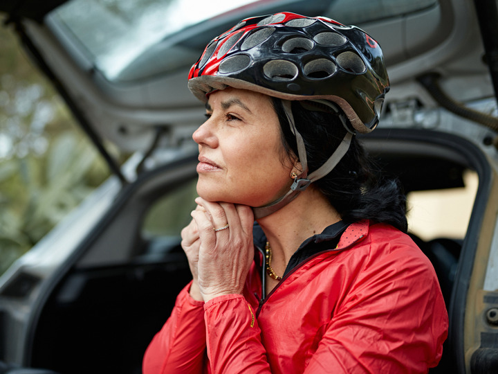 Woman Putting on Helmet