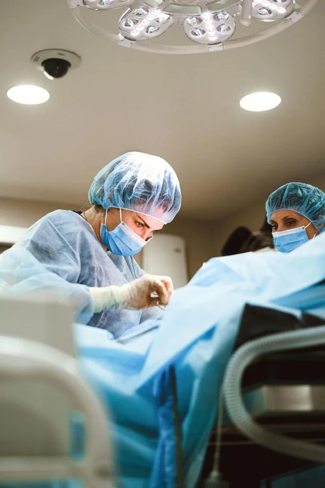 Doctors mid surgery, with little surgery shown