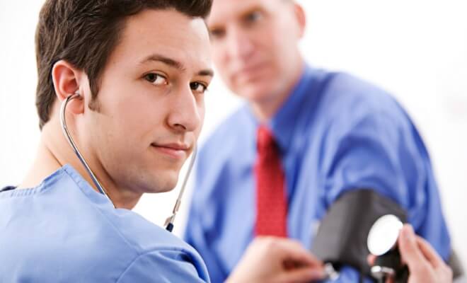 Blood pressure cuff on businessman