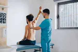 Physician examining patient's back or spine