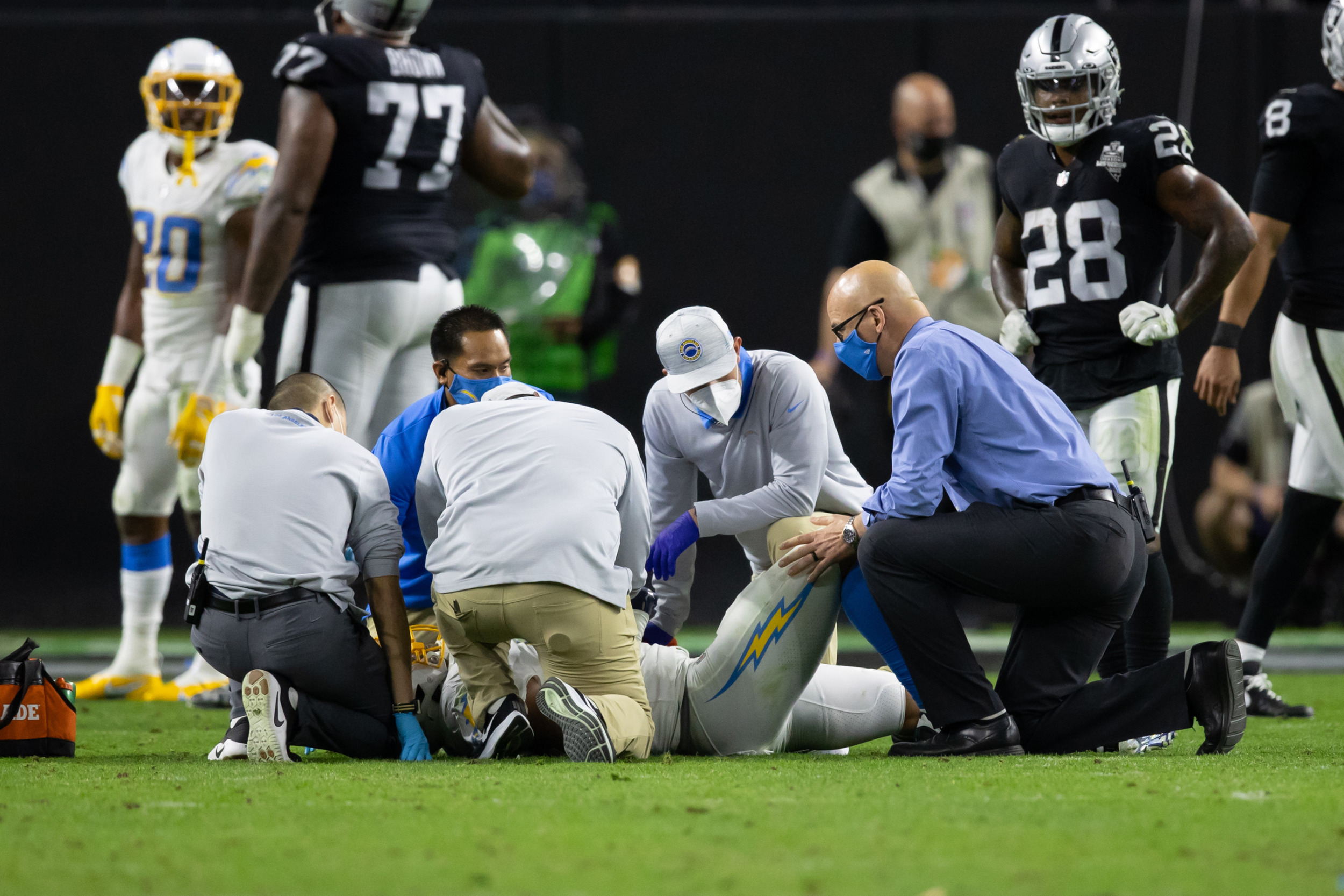 A medical team gathers around an injured player on the Los Angeles Chargers
