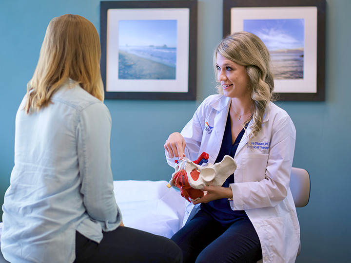 A doctor discussing pelvic health with a patient