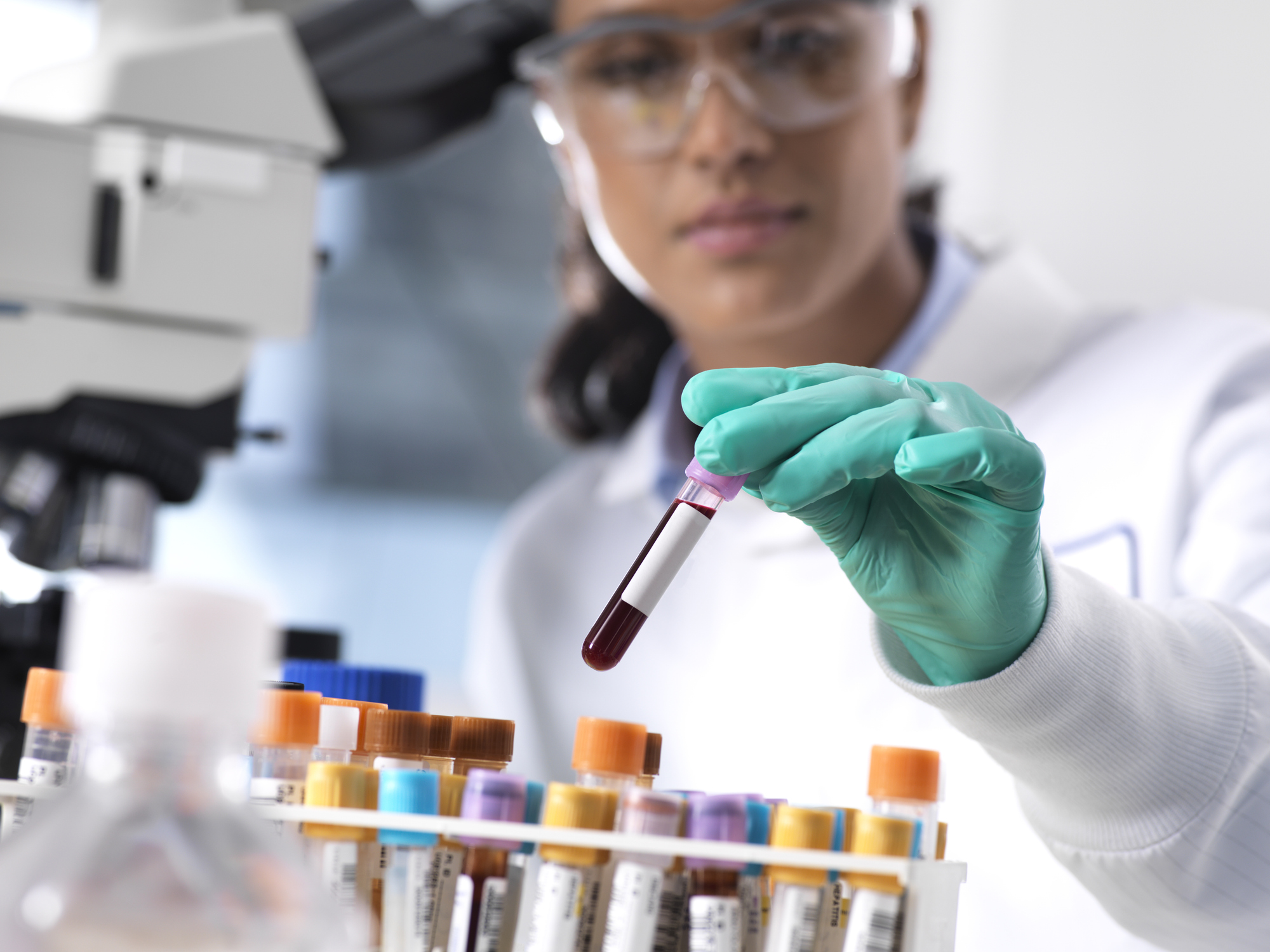 Scientist observing test tubes in laboratory
