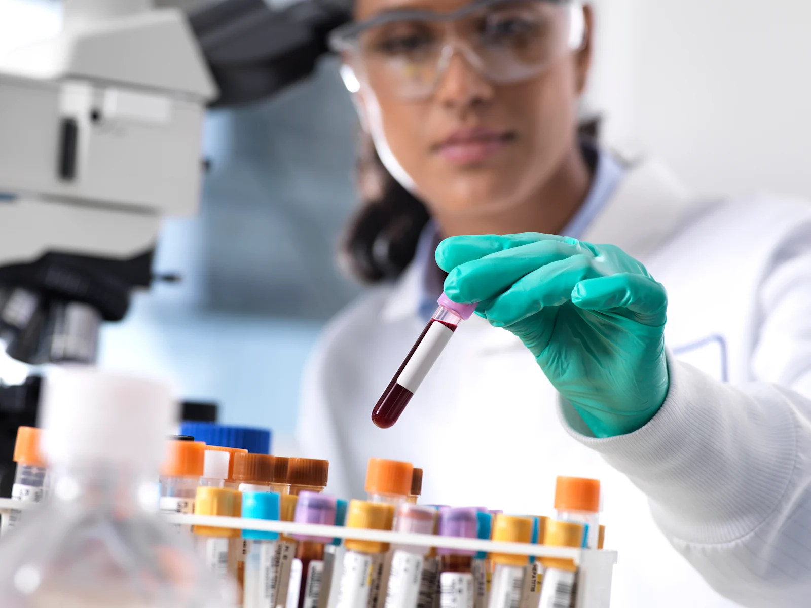 Scientist observing test tubes in laboratory