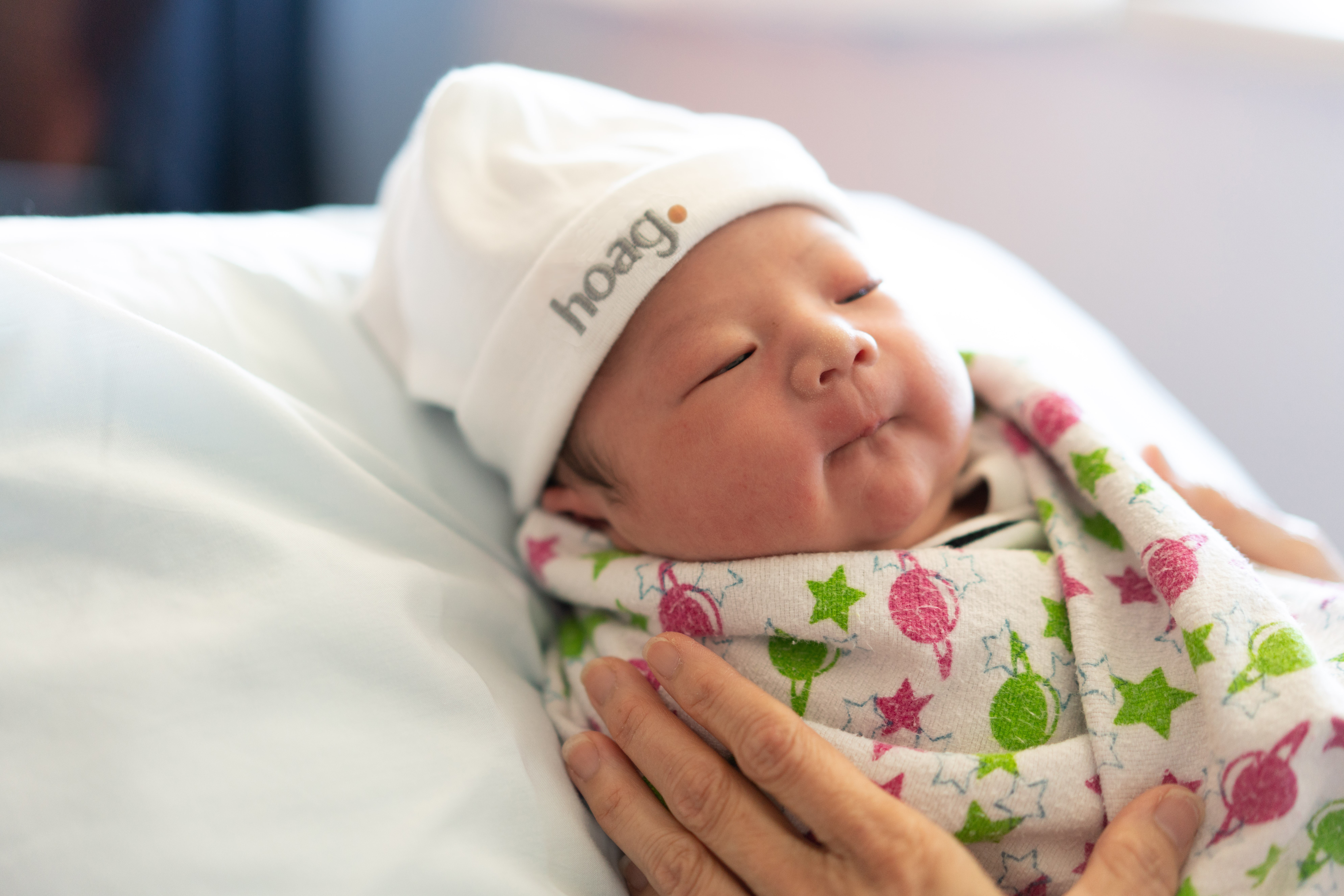 newborn baby in a hoag hat