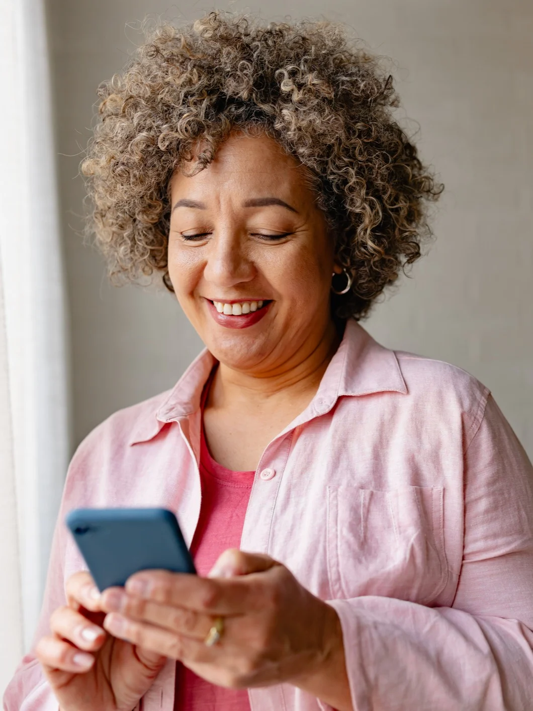 Elderly Woman Smiling at her Phone
