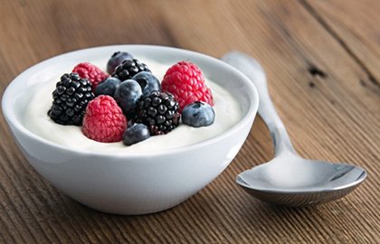 A bowl of yogurt and a spoon