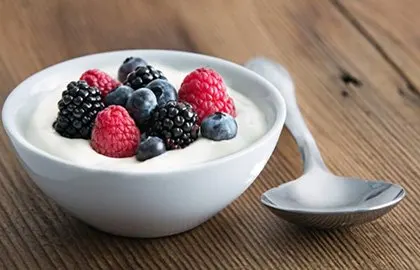 A bowl of yogurt and a spoon