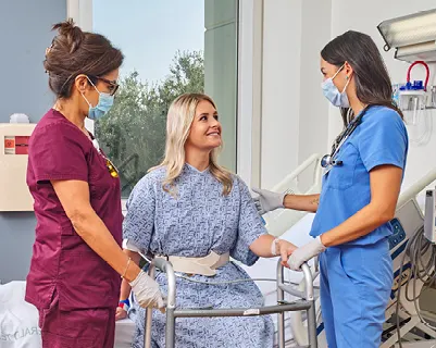 Two doctors meet with a patient at Hoag Orthopedic Institute