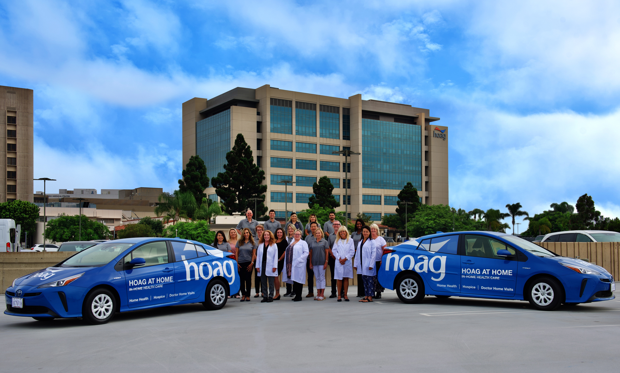 The Hoag at Home team stands with the Hoag at Home cars