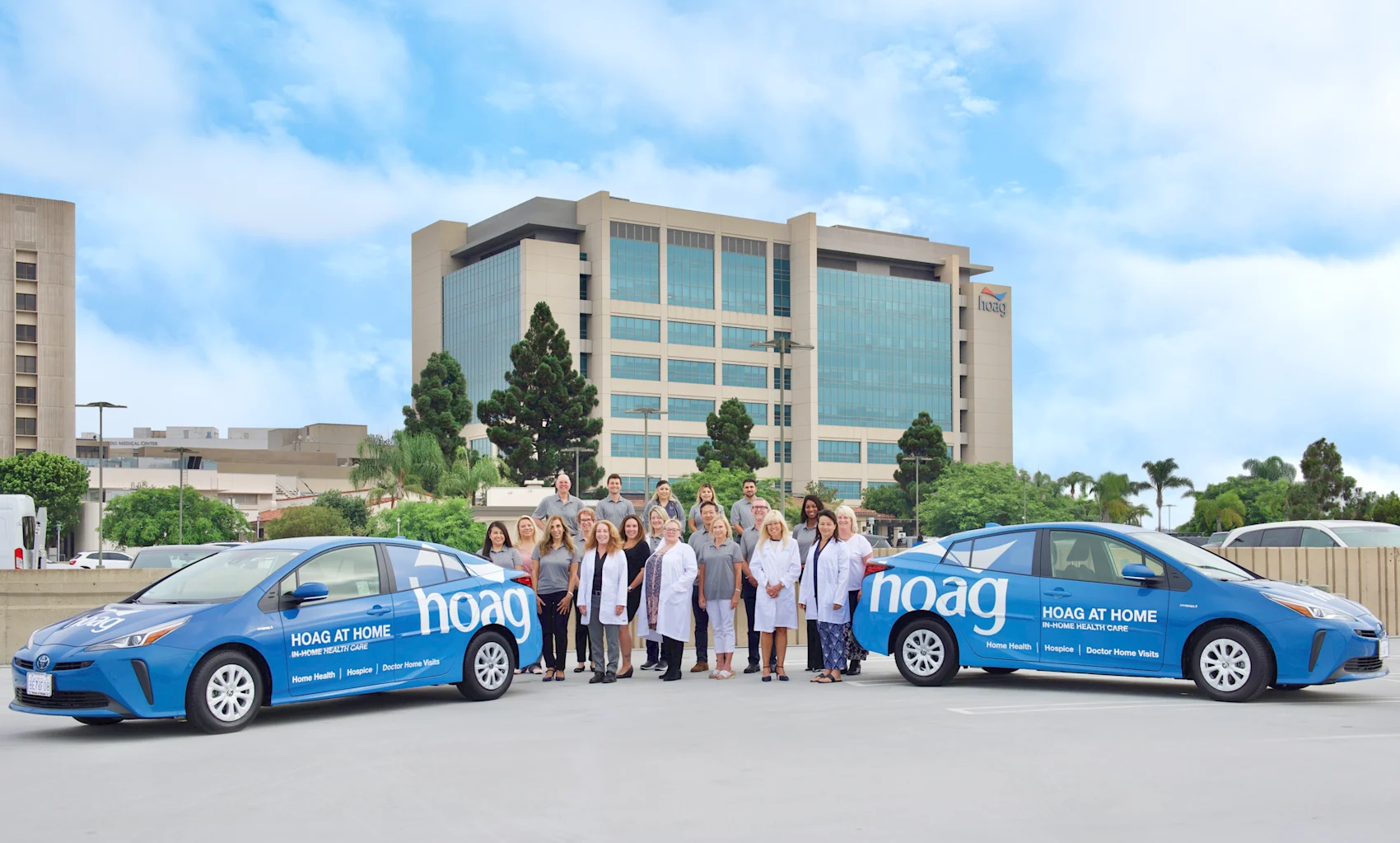 The Hoag at Home team stands with the Hoag at Home cars