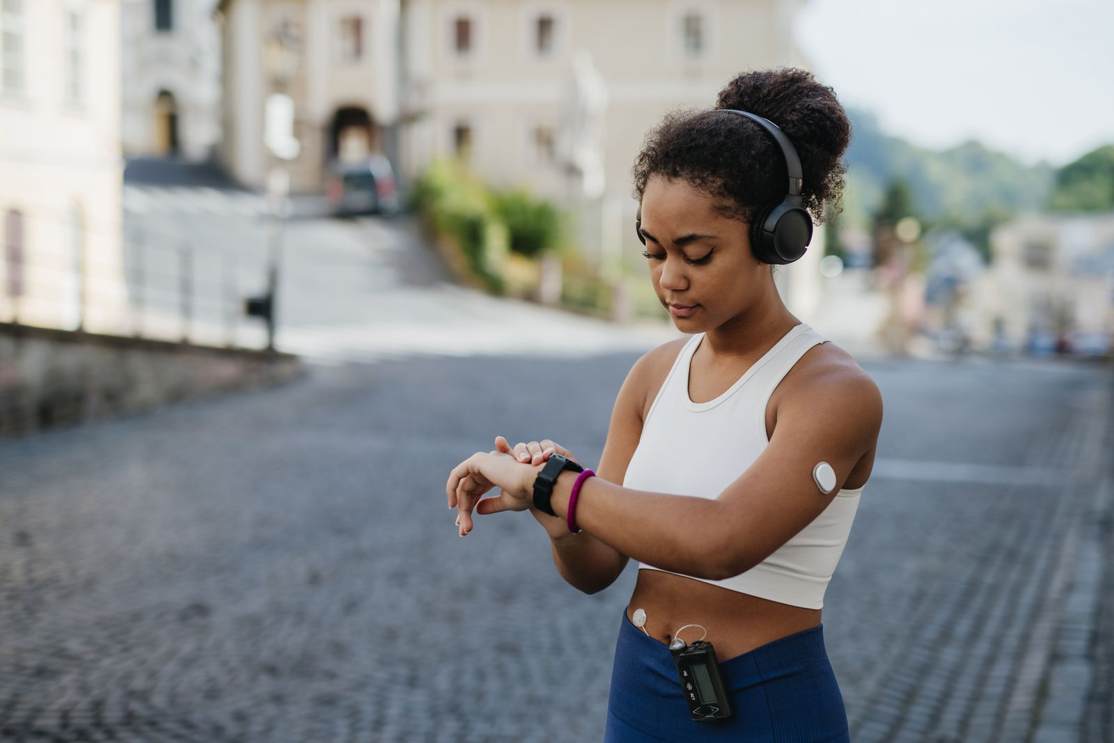 Woman checking watch while running