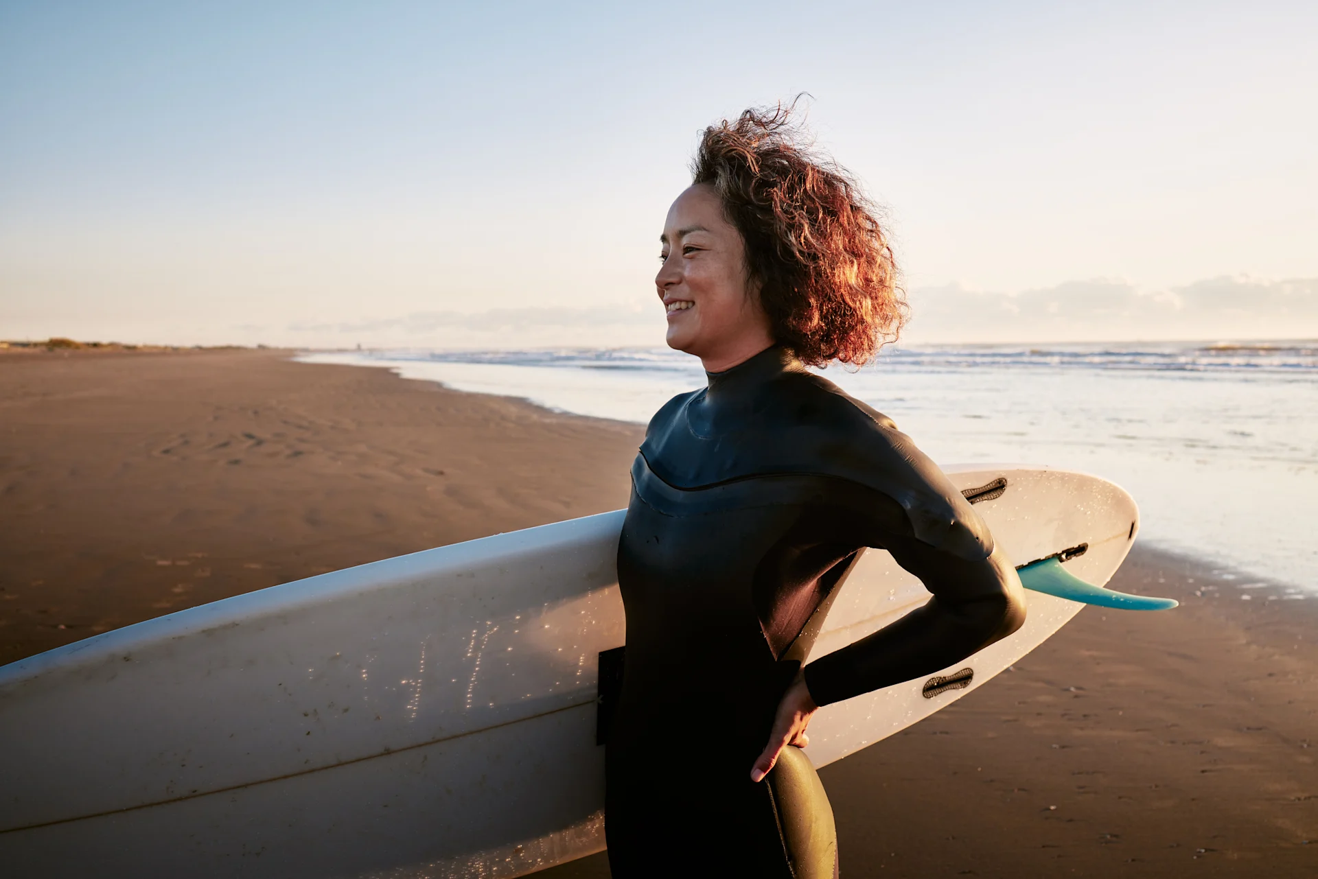 Woman with surfboard at beach