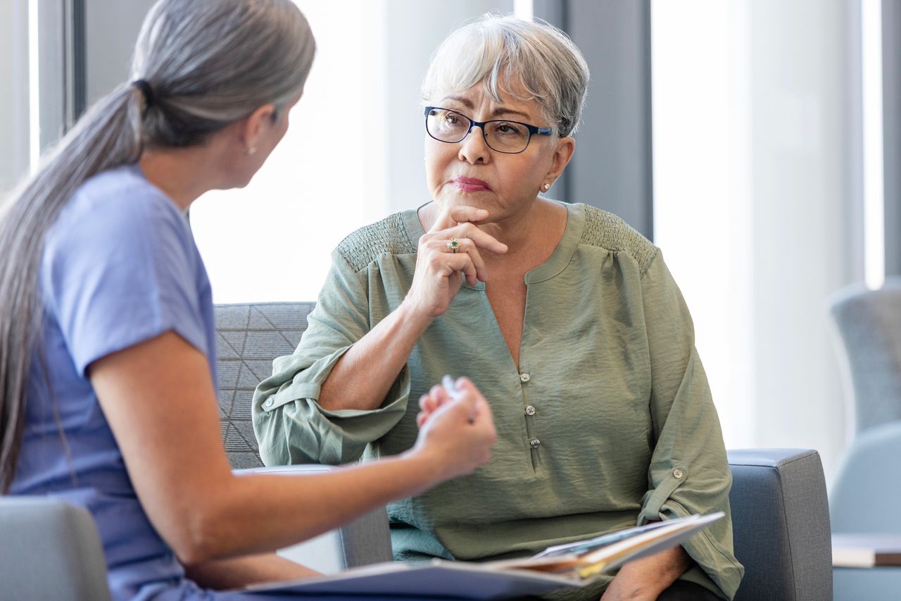 Elderly woman talking to doctor