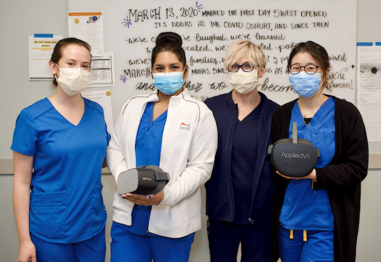 4 nurses pose with some VR equipment