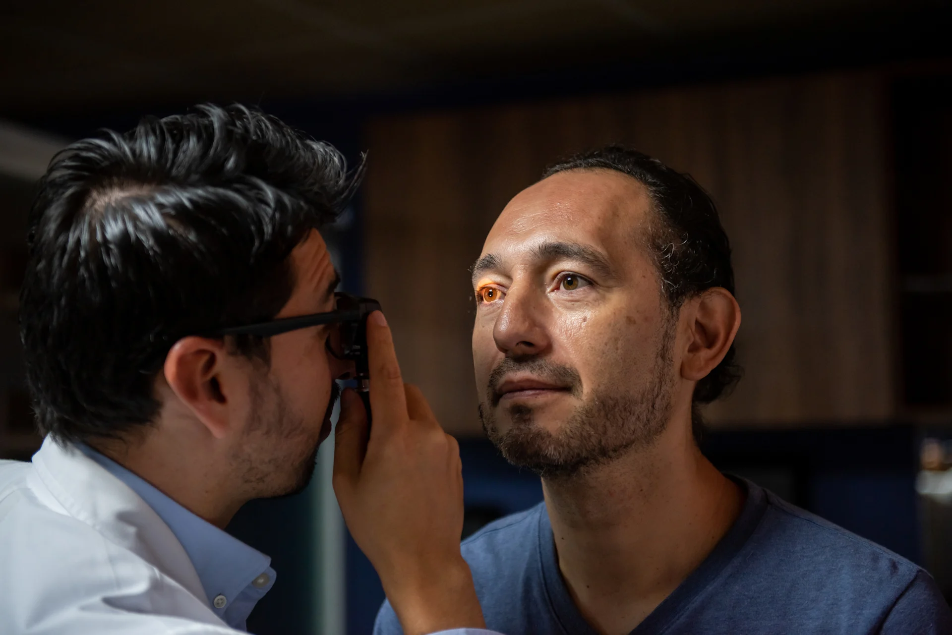 Doctor checking eyes with light