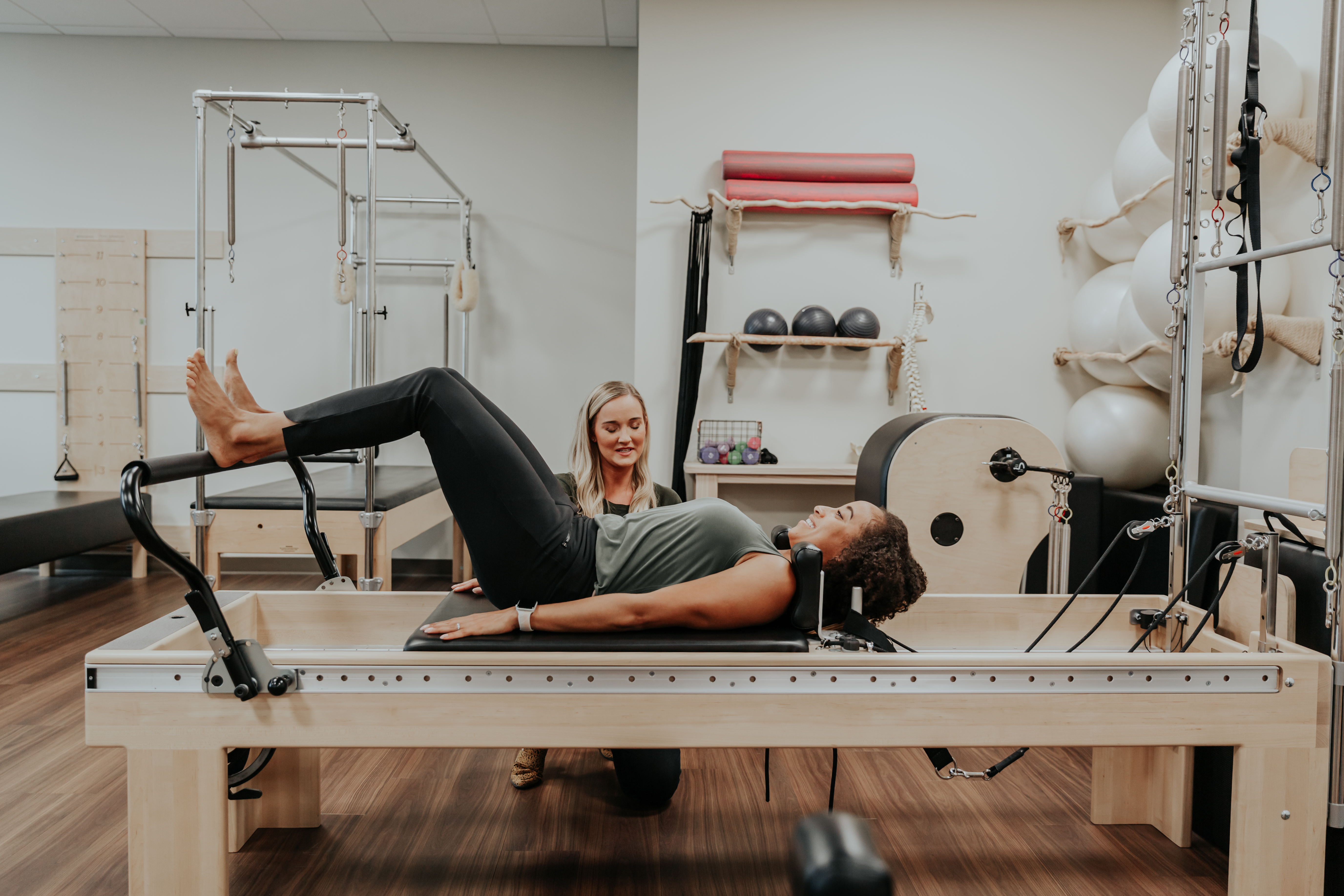 A physical therapist is helping a woman with her pelvic floor condition