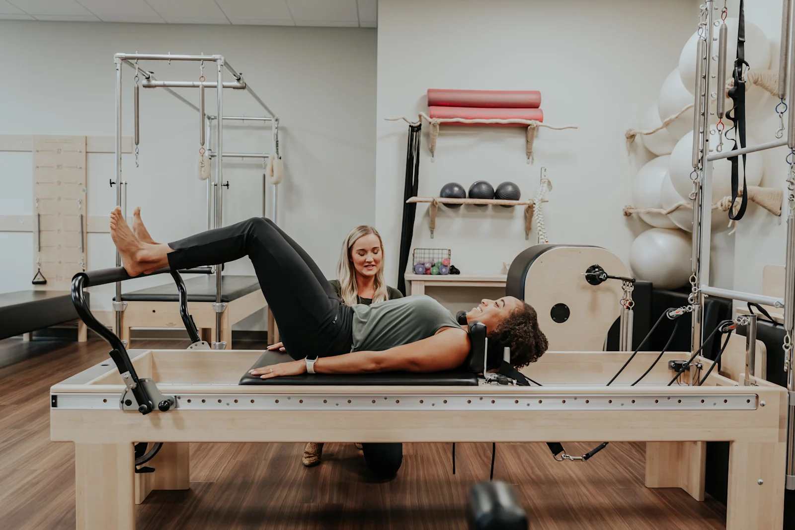 A physical therapist is helping a woman with her pelvic floor condition