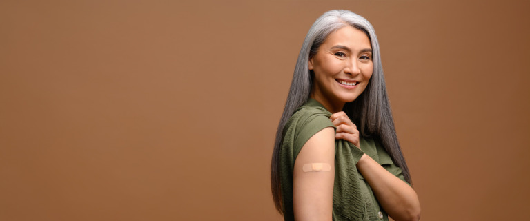 A woman shows her flu shot bandage