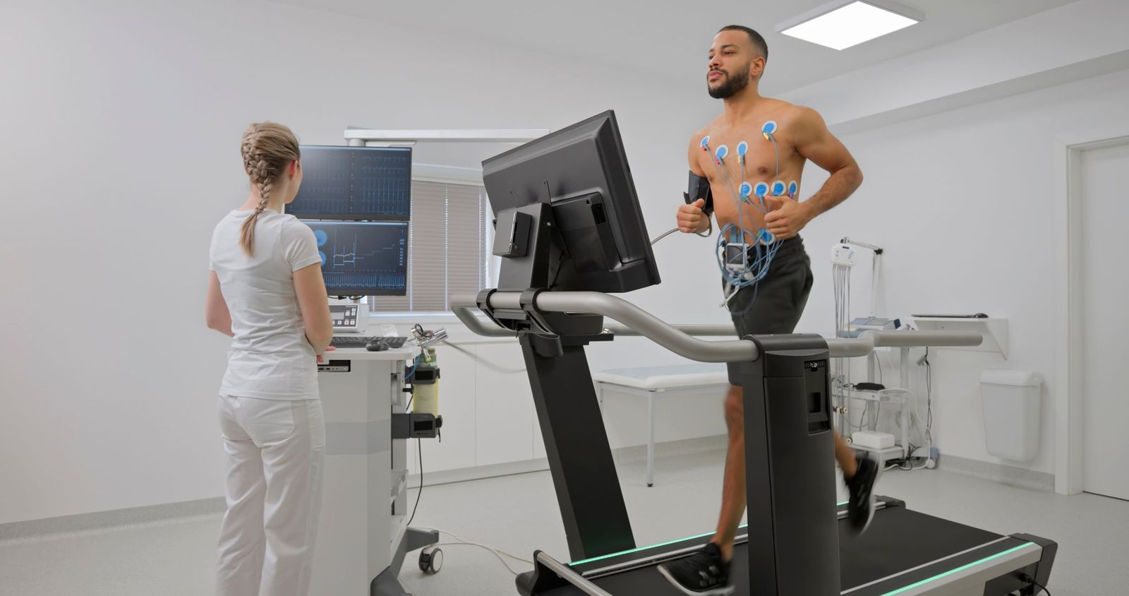 Man on treadmill with monitors