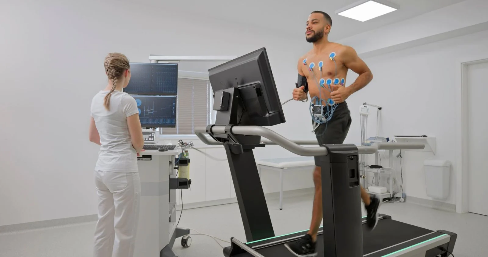 Man on treadmill with monitors