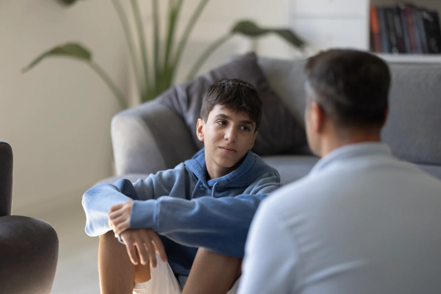 Young boy talking with an adult