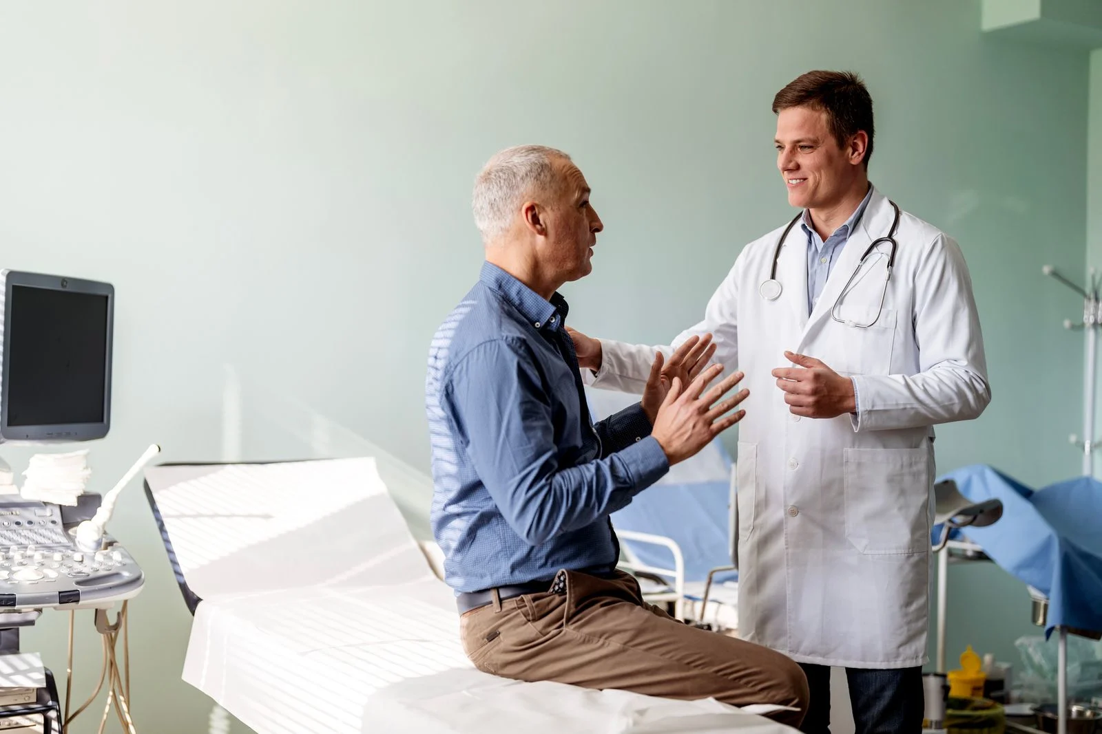 A doctor educating a patient before he has spine surgery