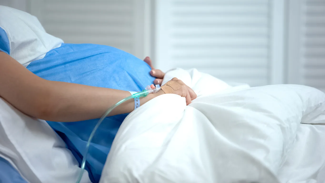 Pregnant woman in hospital bed
