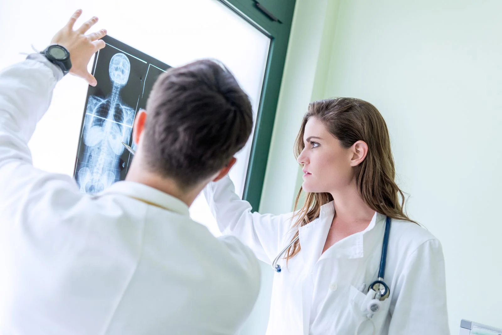 Doctors looking at skeletal x-rays