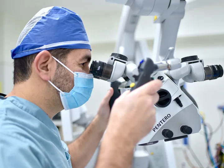 A surgeon is using some equipment