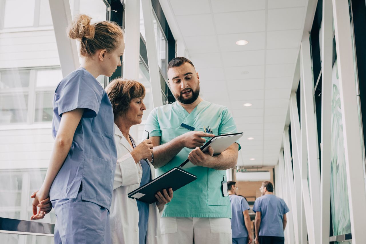 Nurse showing doctor a clipboard