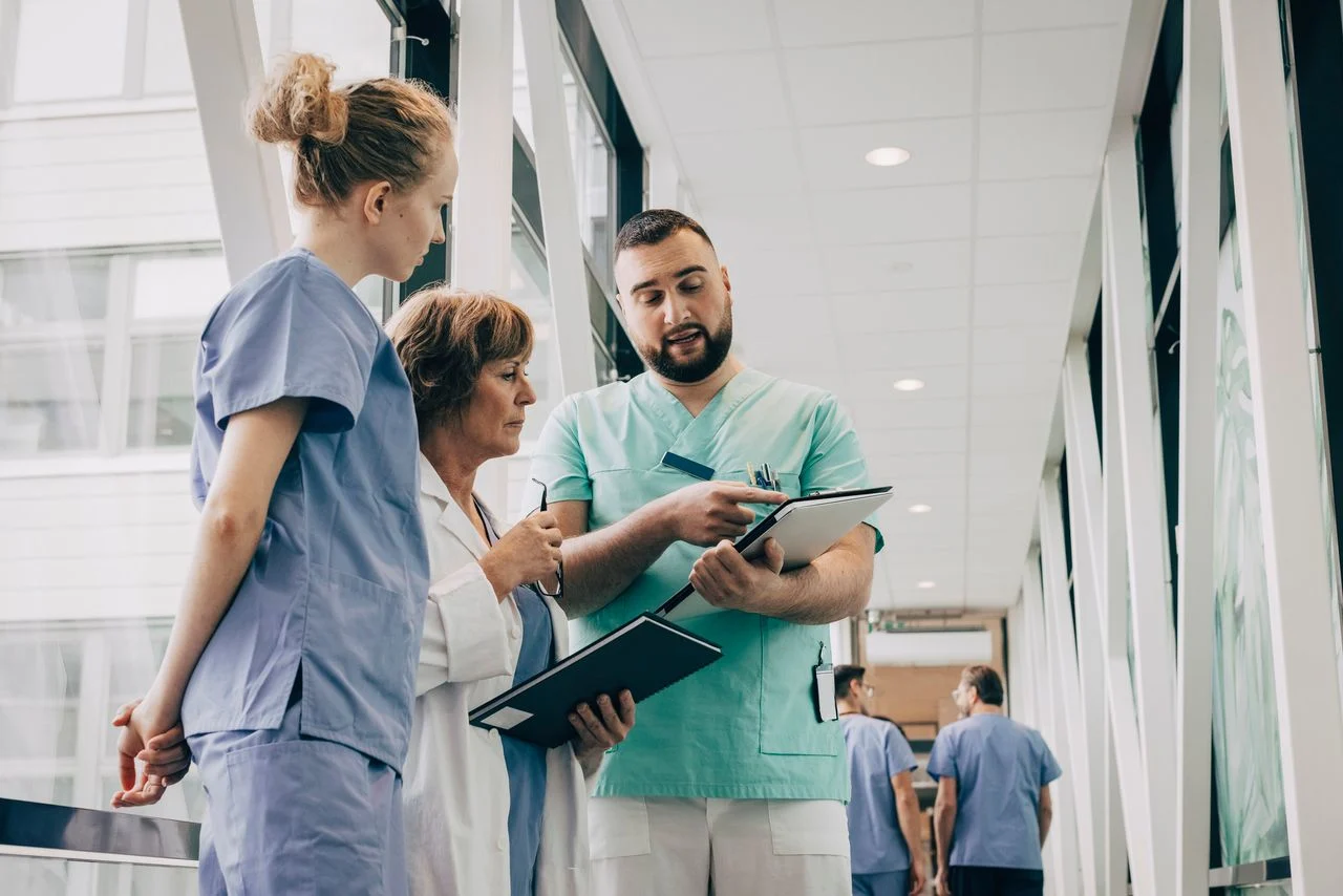 Nurse showing doctor a clipboard