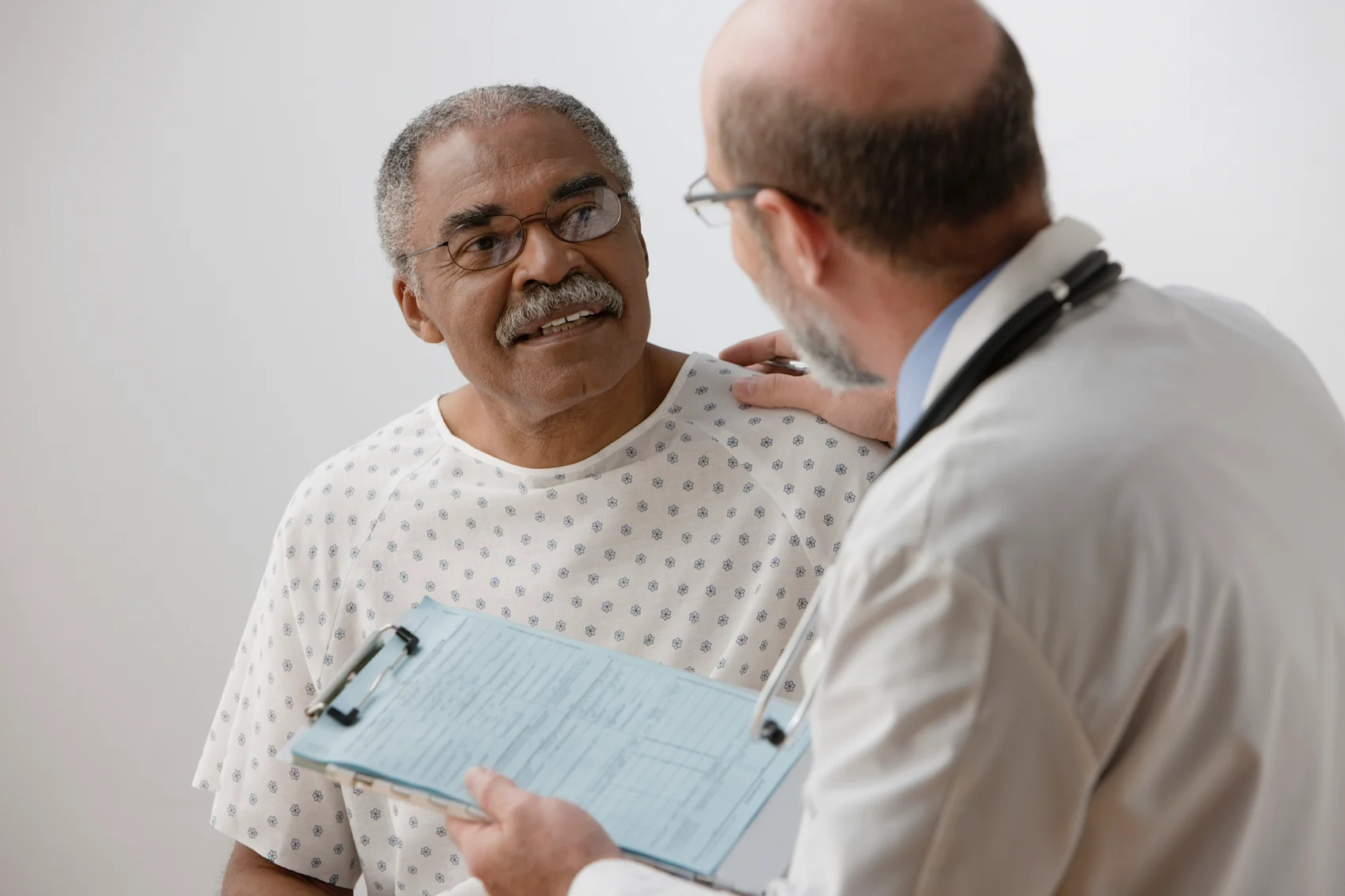Doctor speaking to elderly man