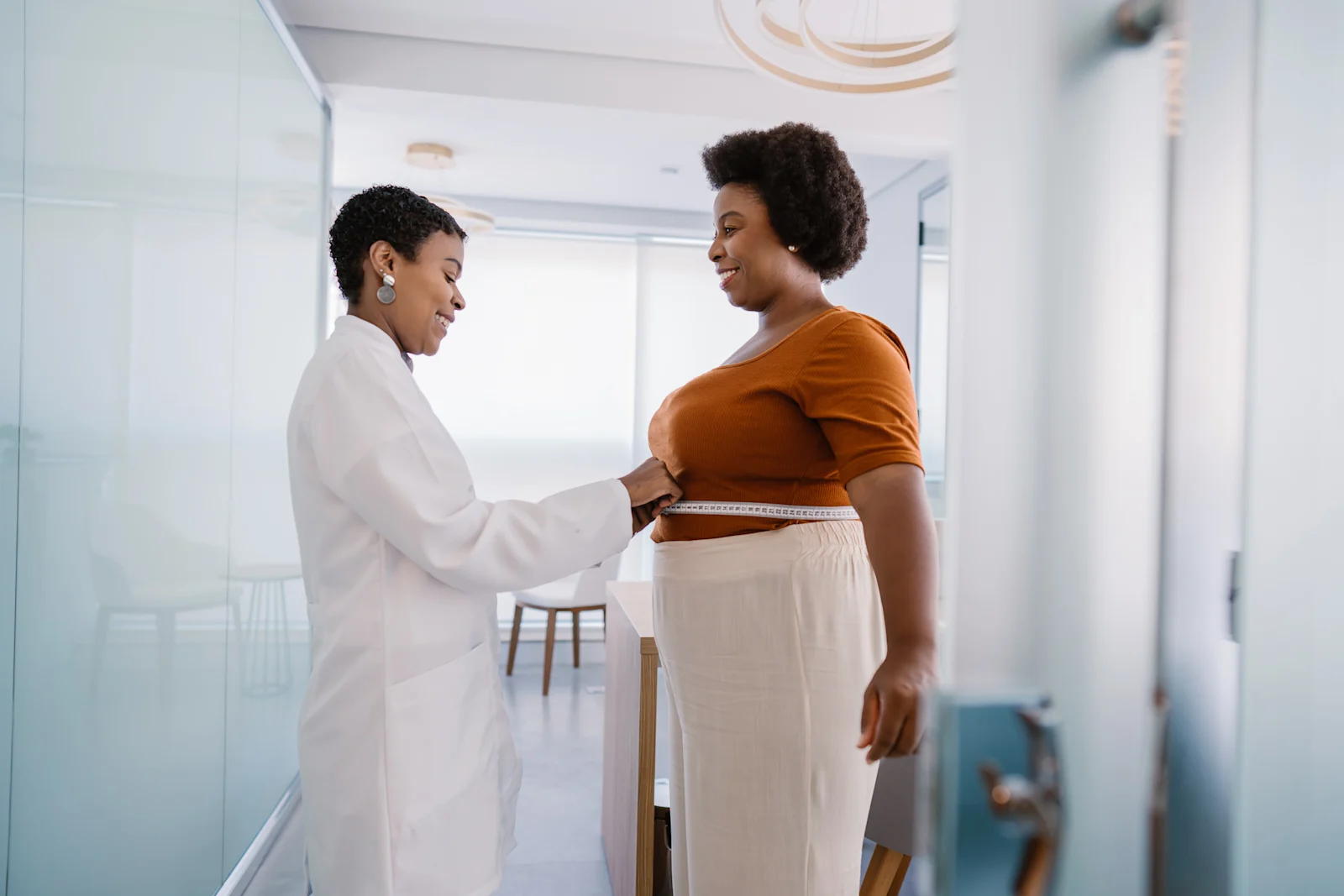 Woman getting her waist measured