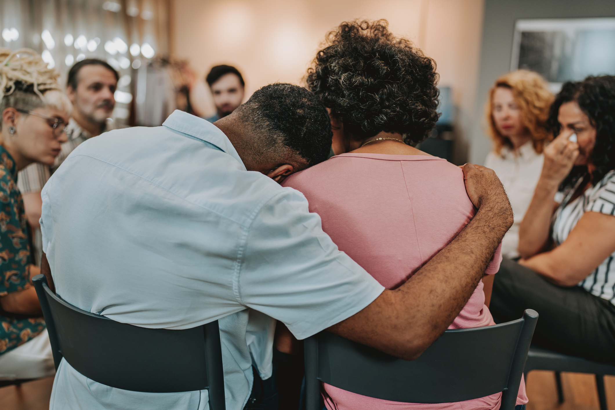 Man with head on woman's shoulder
