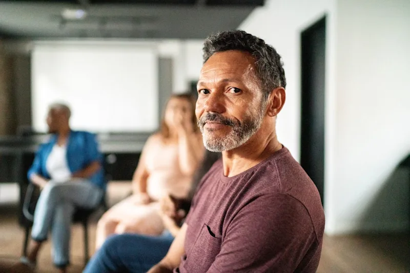 Man in support group smiling
