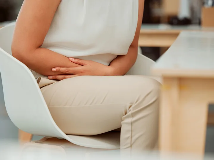 A woman feels pain in her gut