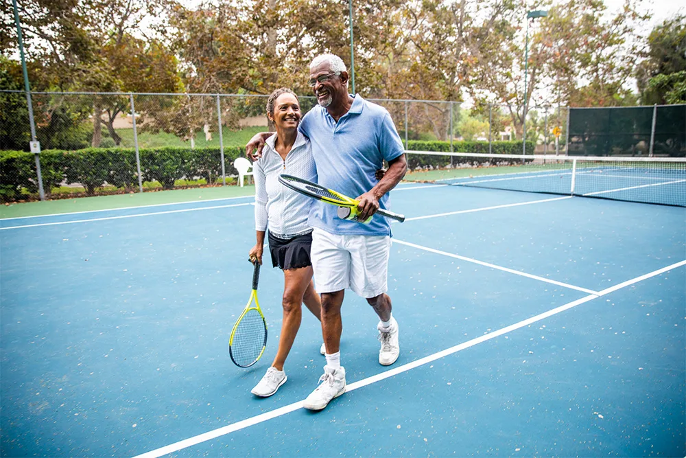 Older couple playing tennis