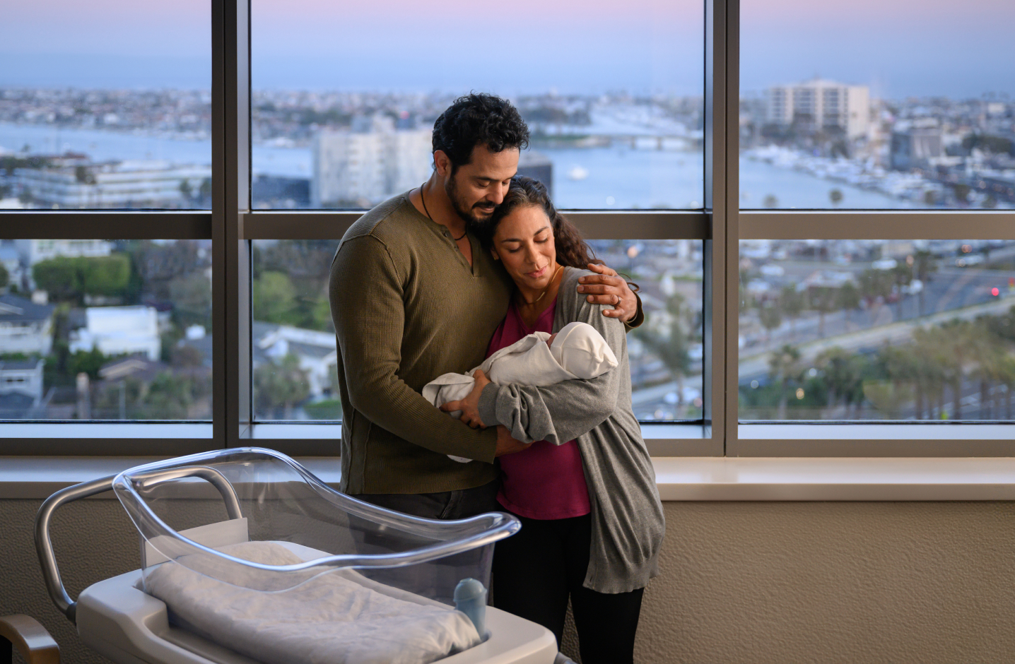 new parents holding newborn
