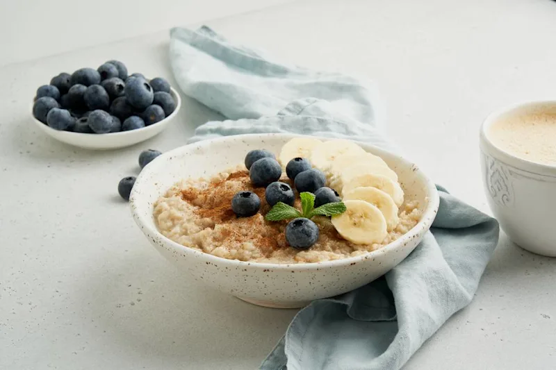 Bowl of oatmeal with bananas and blueberries