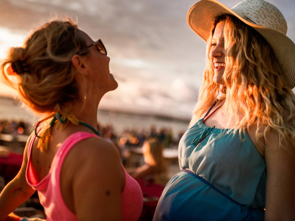 Pregnant women smiling on beach