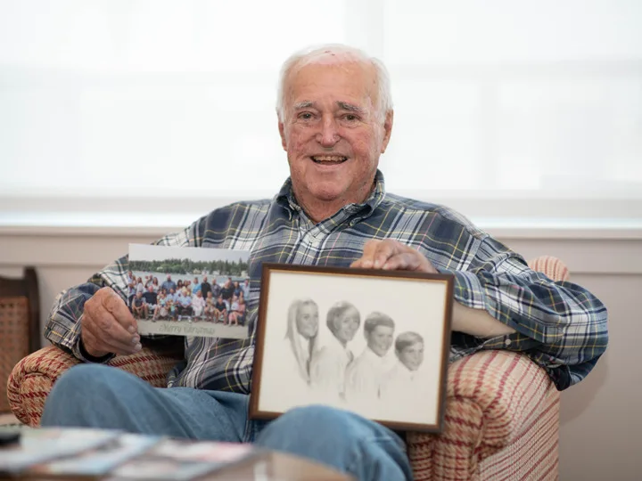 Otis Healy showing his family photos
