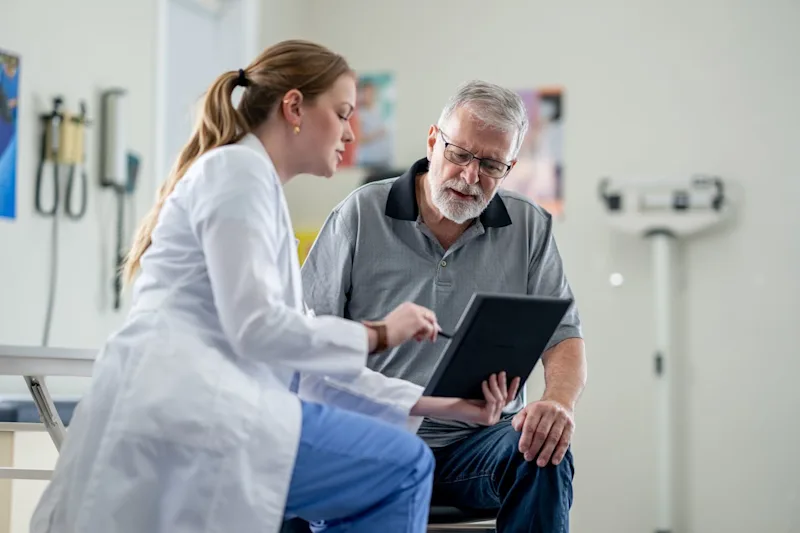 Doctor talking to elderly man