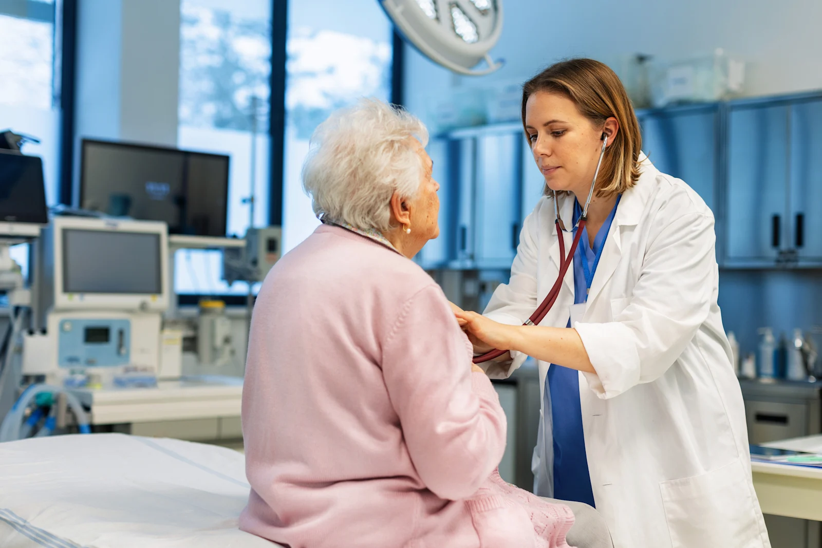 Elderly woman being observed by doctor