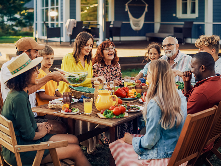 A family gathers for a backyard picnic