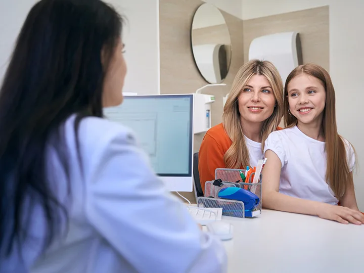 Mother & Daughter Speaking to Doctor